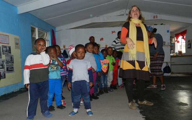 Flower Valley ECD Programme Co-ordinator, Gabrielle Jonker with children at the Good Hope ECD Centre in Masakhane
